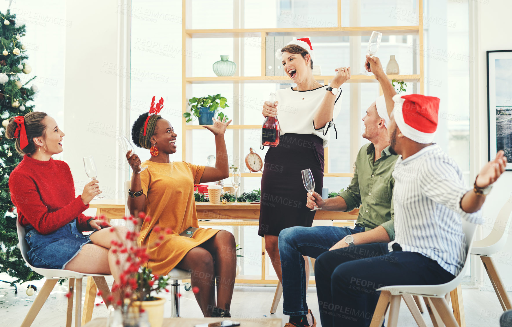Buy stock photo Christmas, party and champagne with business people in office for celebration, merry and festive season. Holiday, xmas and support with employee and wine for diversity, event and content together
