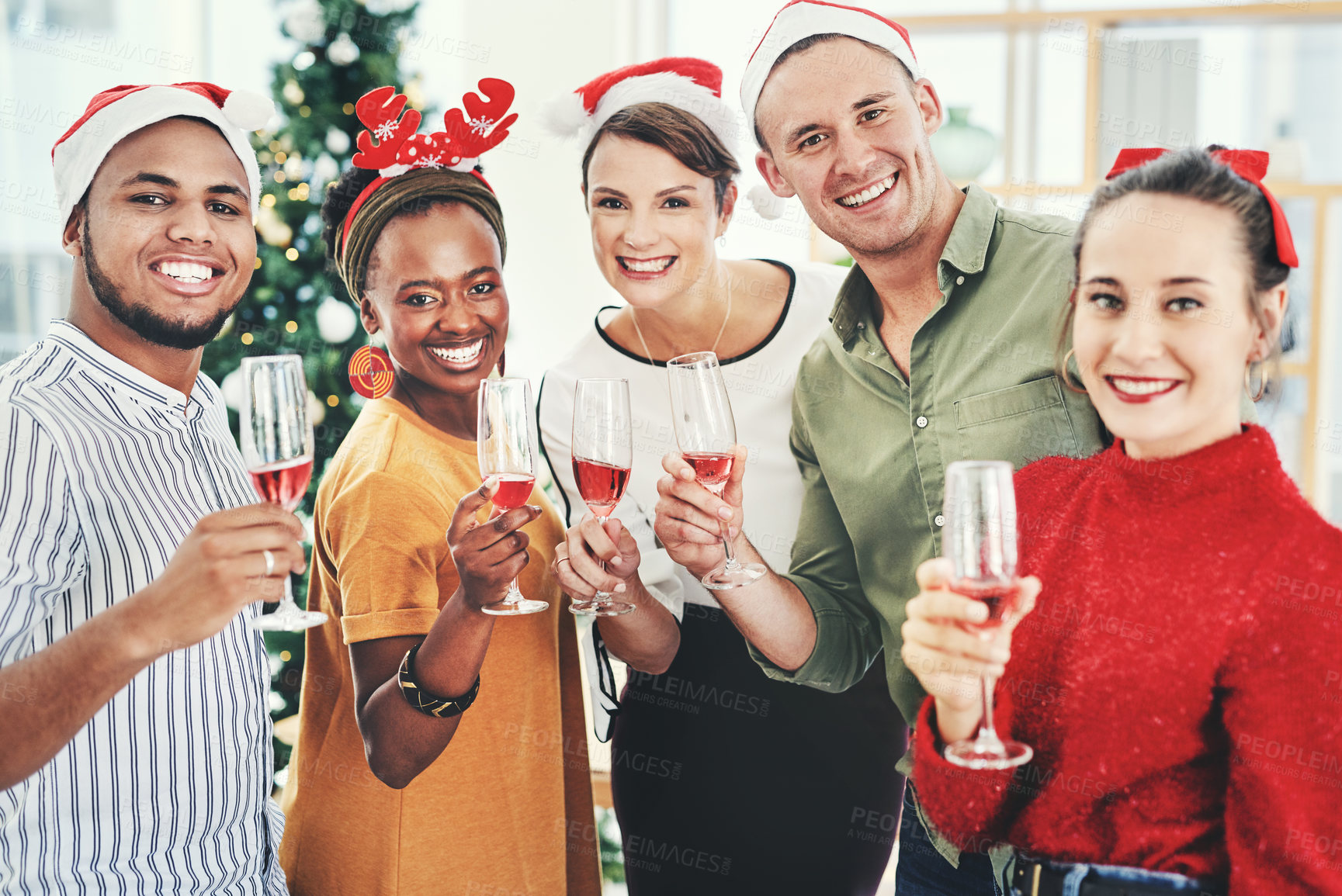 Buy stock photo Portrait of a group of creative businesspeople drinking champagne and celebrating together at their office Christmas party