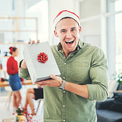 Buy stock photo Christmas, coworking office and gift for excited and happy business man during holiday celebration with secret Santa present. Portrait of an employee holding gift box surprise at workplace event