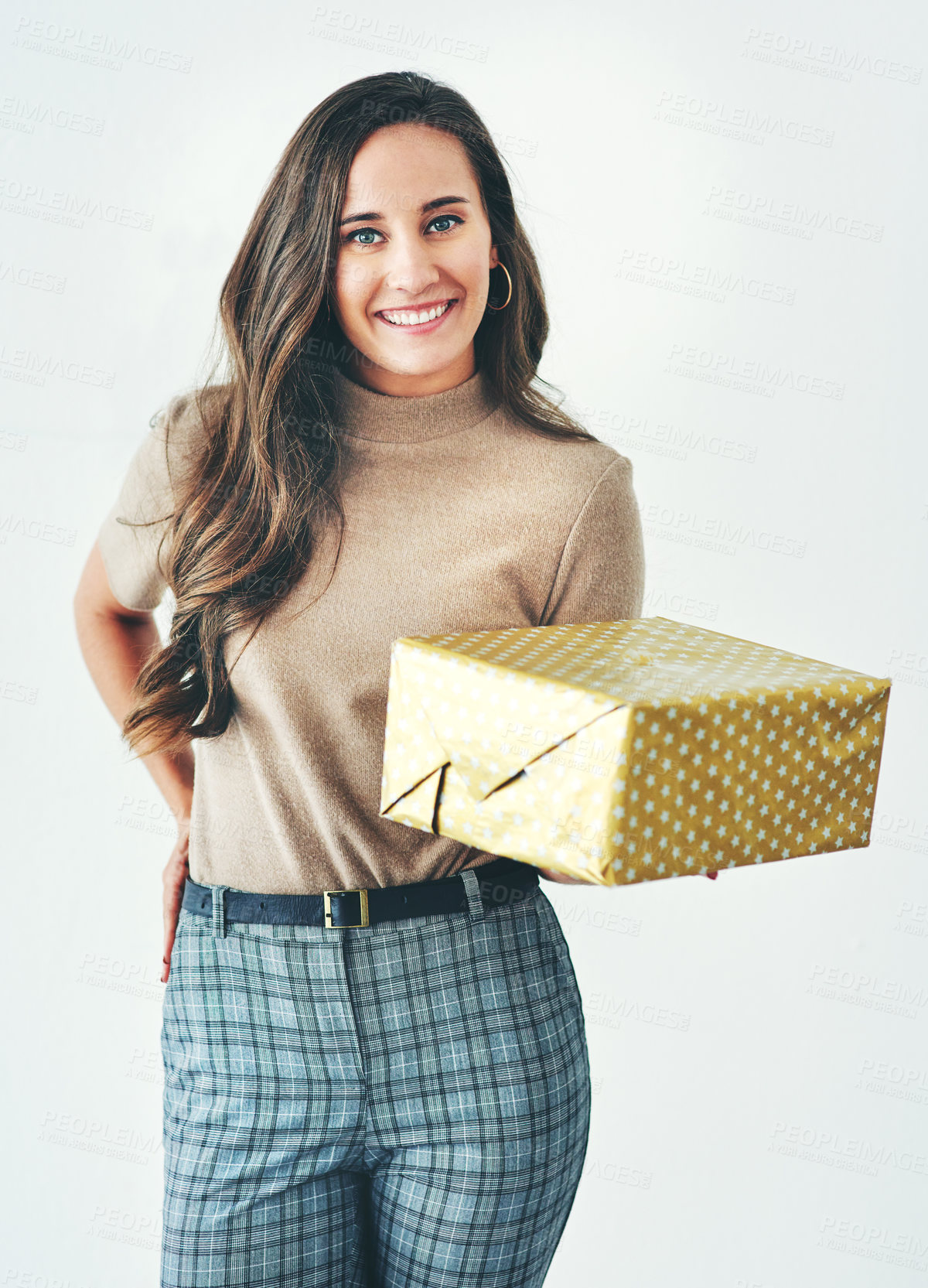 Buy stock photo Christmas, birthday or holiday with woman giving gift or present to celebrate and surprise on a studio background. Portrait of a female with a smile, happiness and kindness holding a mockup gift box