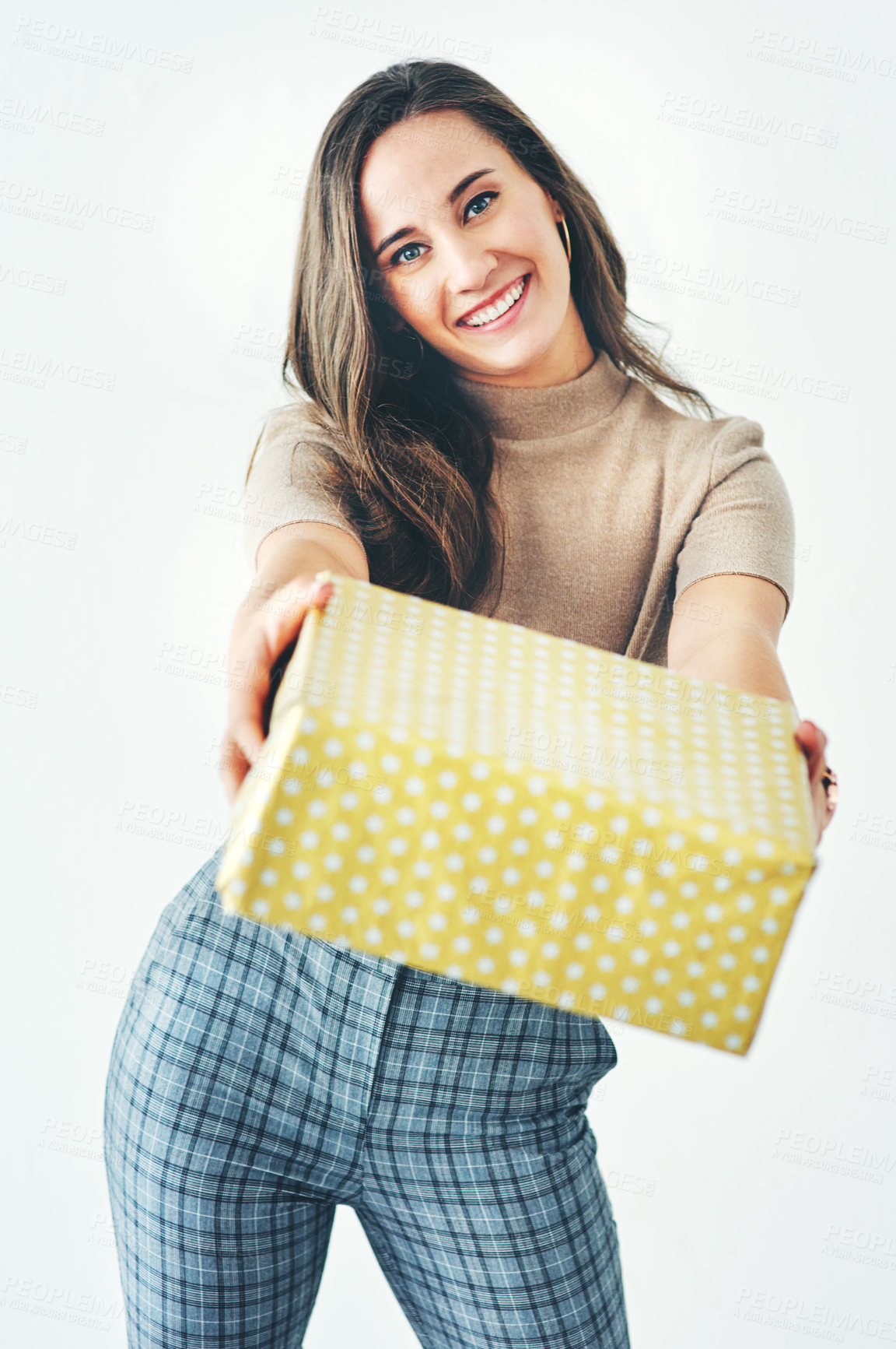 Buy stock photo Portrait, studio and woman giving gift isolated on a gray background. Happy, smile and young female from Canada holding box of presents for Christmas party, new year celebration or birthday event.