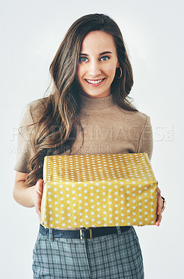 Buy stock photo Gift, woman and present for celebration, christmas or birthday on a studio background for happiness, giving and kindness. Portrait of a model with gift box to celebrate surprise holiday mockup