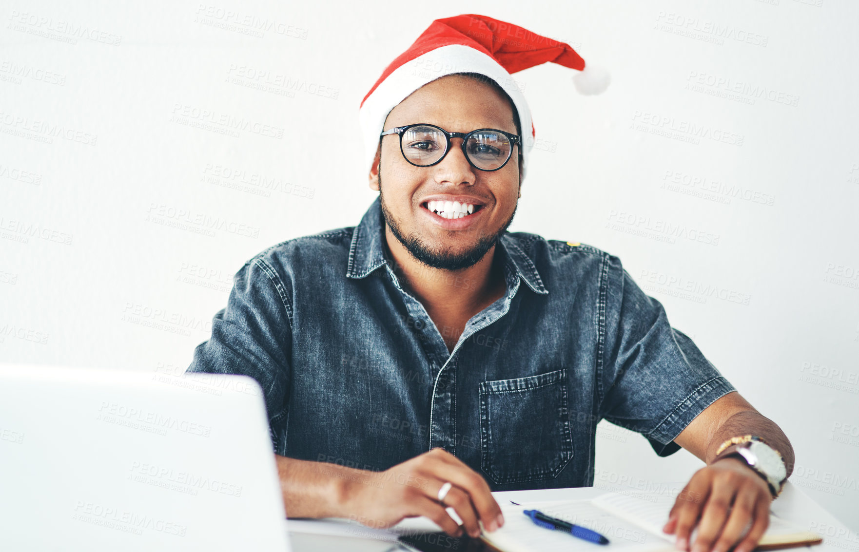 Buy stock photo Portrait of a handsome young businessman working in his office on Christmas Eve
