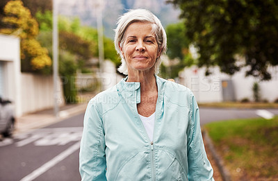 Buy stock photo Portrait of a cheerful senior woman having a quick jog on her own outside in a suburb