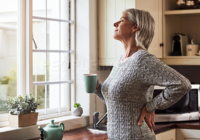 Buy stock photo Cropped shot of a relaxed senior woman preparing a cup of tea with CBD oil inside of it at home during the day