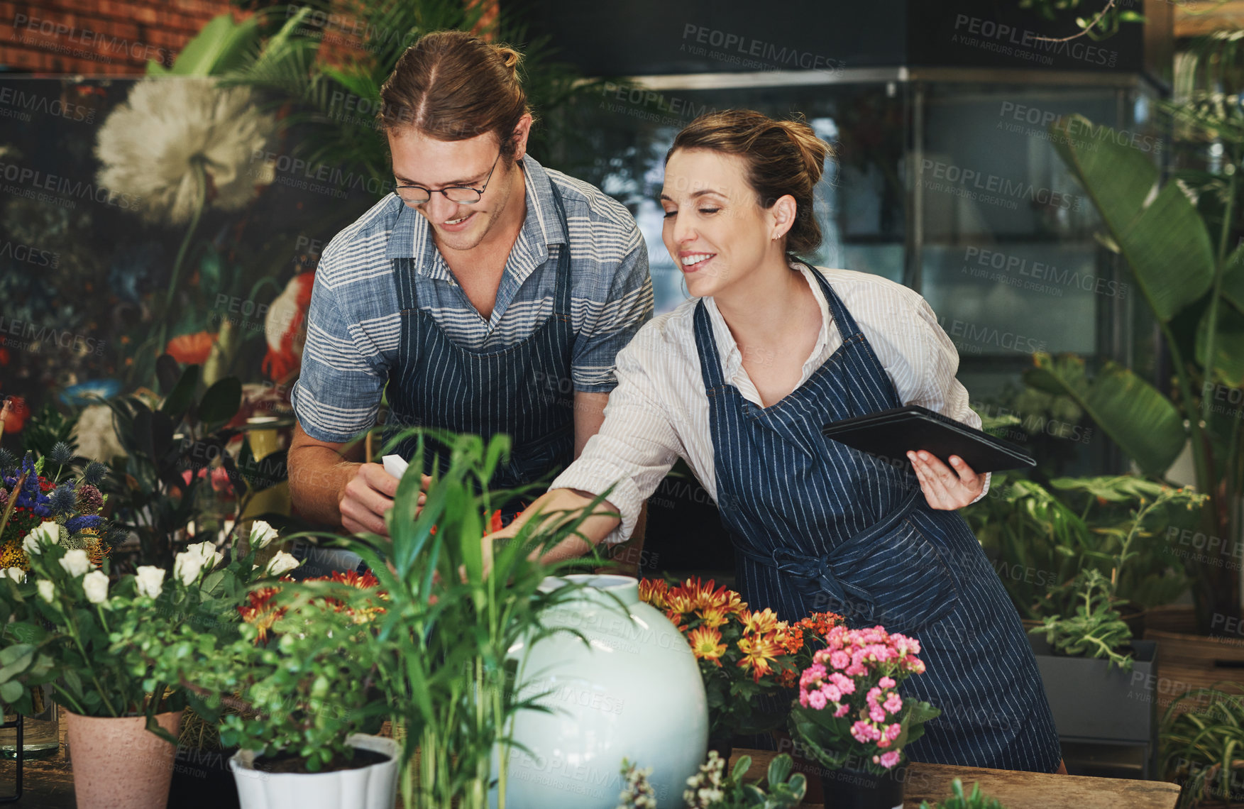 Buy stock photo Business people, flower store and teamwork with tablet, startup and check inventory. Professional, plant nursery and man with woman with tech, digital app and connection with organic growth or nature