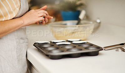 Buy stock photo Baker hands, baking tray and cupcakes prepare in kitchen in house for relax or therapeutic hobby. Dessert, cooking and professional person with homemade for small business or home recipe with paper.