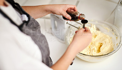 Buy stock photo Cropped shot of an unrecognizable woman adding vanilla essence to her cake mixture