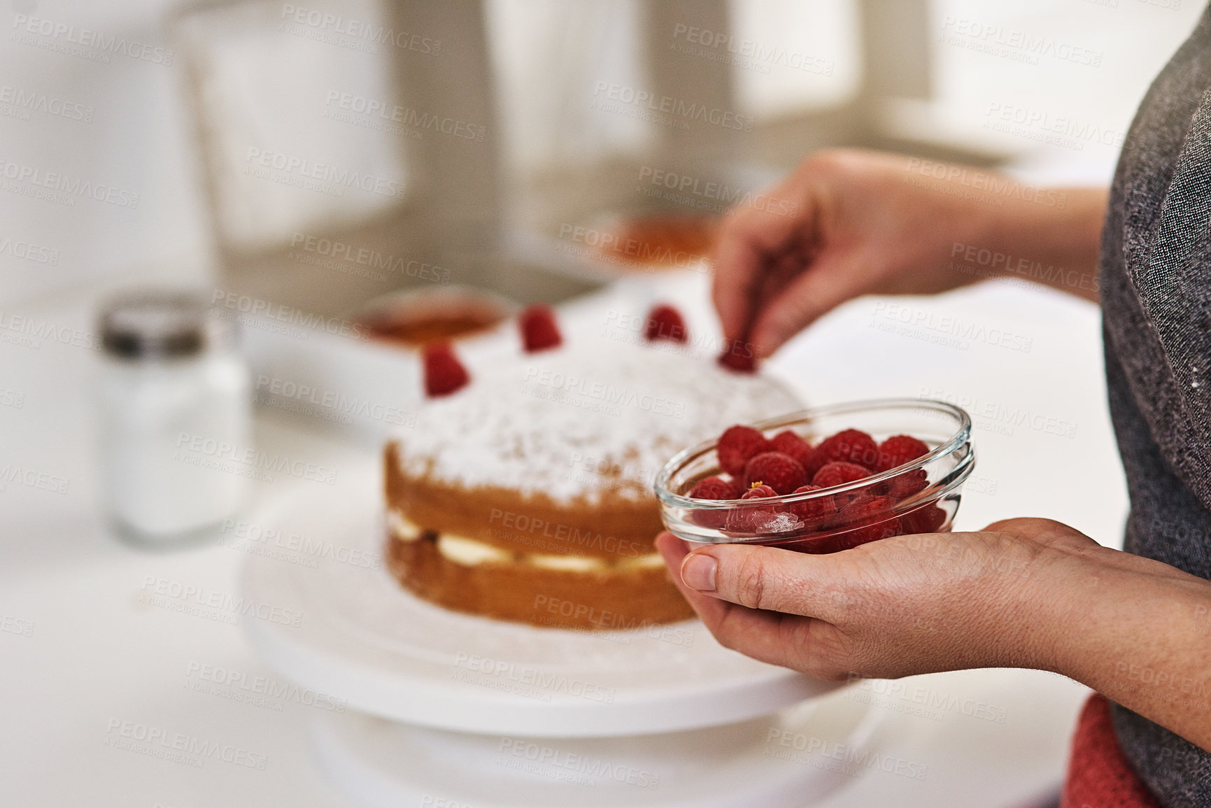 Buy stock photo Cake, decoration and hands of person with raspberry for small business, bakery and creativity in food. Sweet, snack and fruit with dessert on table for pastry shop, confectionery and preparation