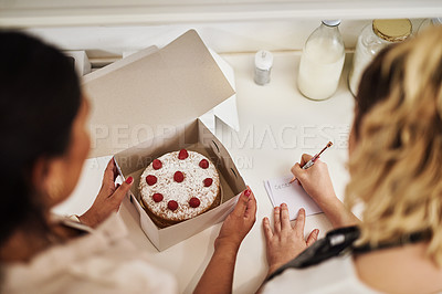 Buy stock photo Cropped shot of two bakers preparing a cake order