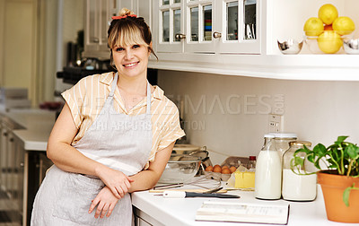 Buy stock photo Happy, woman and baking in kitchen for portrait with recipe book, ingredients and equipment with apron for dessert. Smile, female chef and reading for information, prepare and food for meal at house