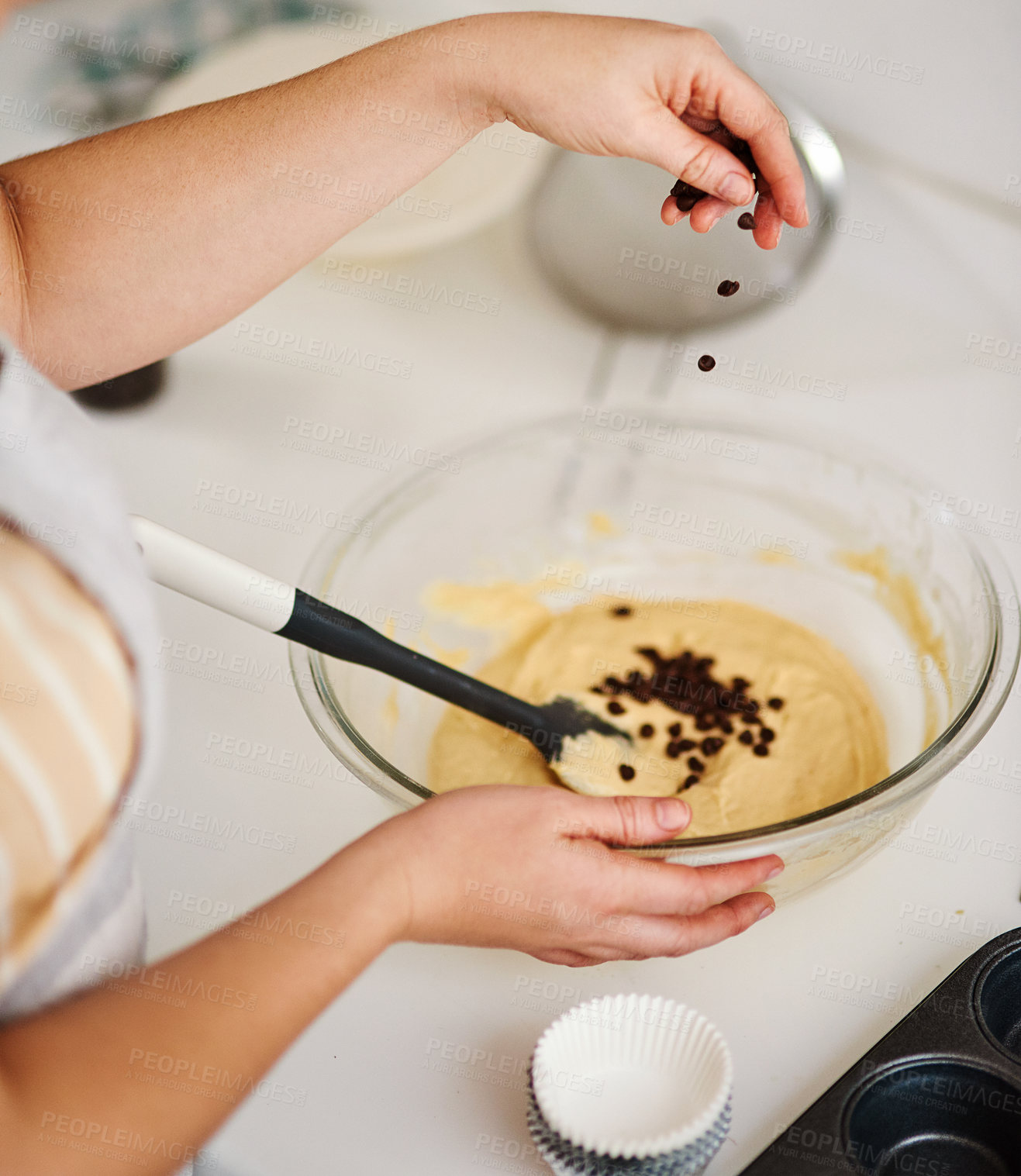 Buy stock photo Bowl, baking and cupcakes prepare in kitchen or house for relax or therapeutic hobby with chocolate chips. Dessert, cooking and professional person for small business or home recipe with hands.