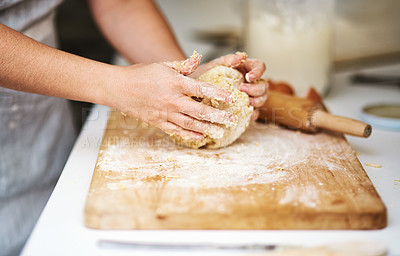 Buy stock photo Cropped shot of an unrecognizable woman forming a ball of dough