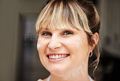 Buy stock photo Cropped shot of a woman posing in her kitchen with flour on her face