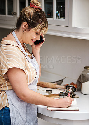 Buy stock photo Woman, cooking or writing with phone call for recipe, talking or meal ingredients in kitchen or home. Notebook, chef or happy baker with smile in discussion, communication or conversation on mobile