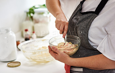 Buy stock photo Cropped shot of an unrecognizable woman mixing icing in a glass bowl