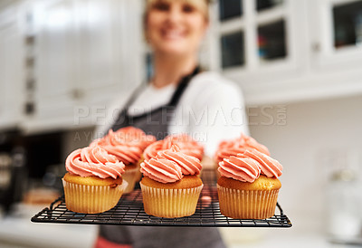 Buy stock photo Tray, smile and woman with cupcakes in kitchen with fresh baked at home with pride for hobby. Portrait, happiness and small business in career with dessert or confidence for cooking in house bakery