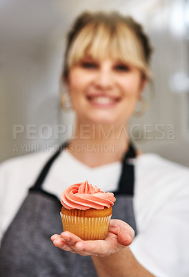 Buy stock photo Woman, chef and cupcake in hand at bakery with dessert production and service in hospitality. Happy, baker and person with cake, muffin or pride for sweet product in small business or kitchen