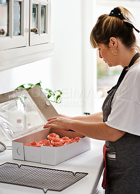 Buy stock photo Cropped shot of a woman preparing orders in her home bakery