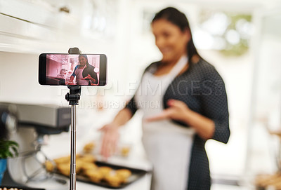 Buy stock photo Cropped shot of a woman being recorded on a cellphone while baking in the kitchen
