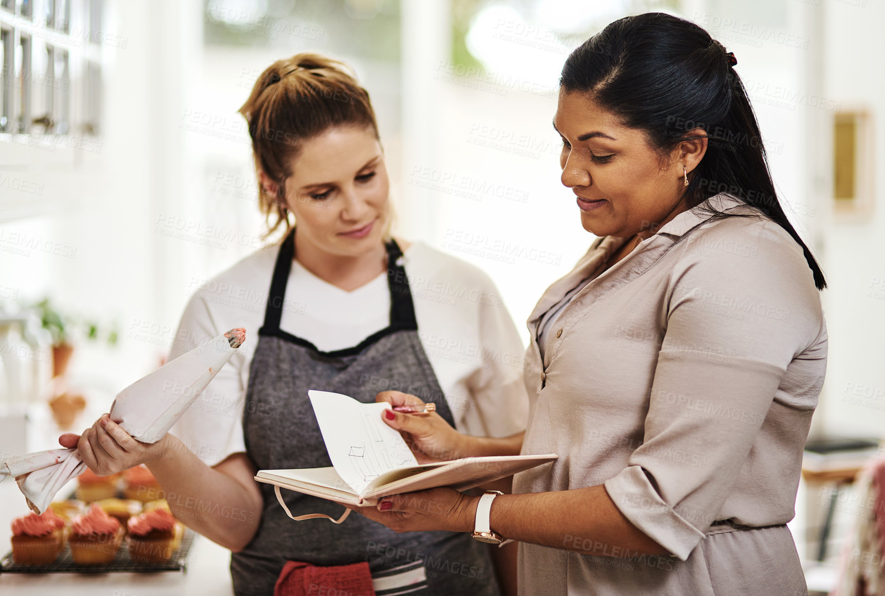 Buy stock photo People, notes or teamwork for cooking recipe, talking or meal ingredients in house kitchen for menu. Startup, women or bakers with notebook in discussion, communication or conversation for business