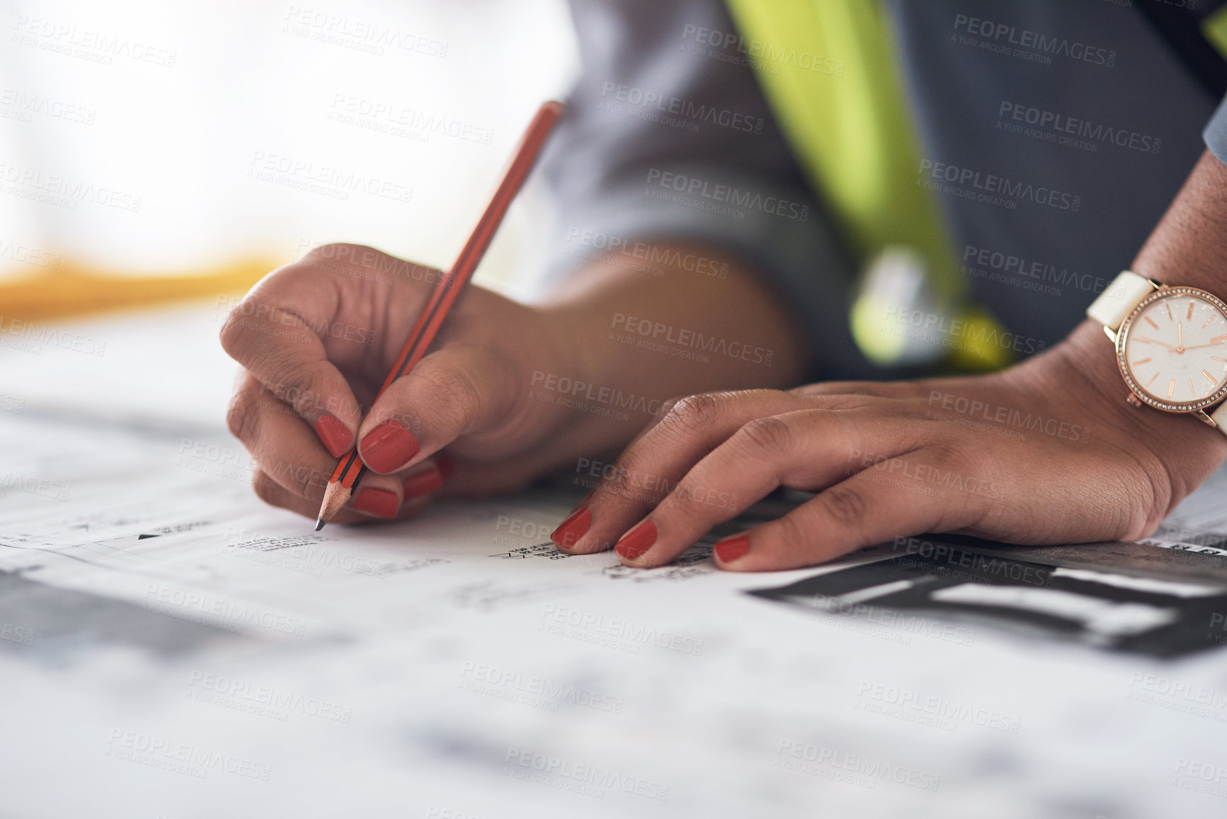 Buy stock photo Cropped shot of an unrecognizable female construction worker looking over plans on site