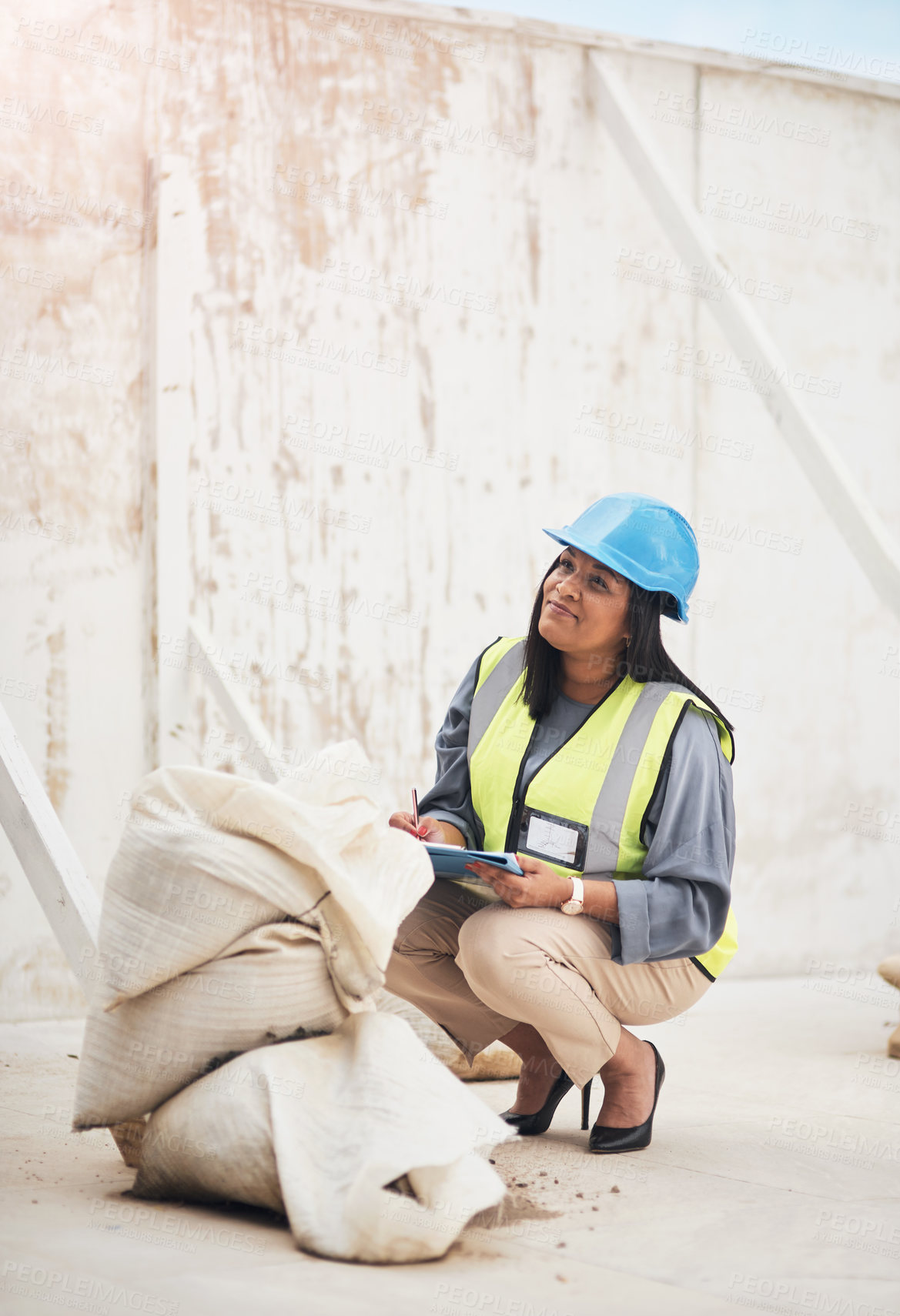 Buy stock photo Full length shot of an attractive young female construction worker working on site