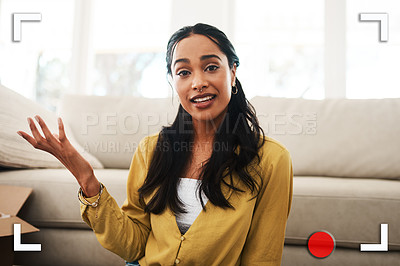 Buy stock photo Cropped portrait of an attractive young businesswoman sitting in her living room and talking to her followers on her vlog