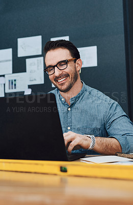 Buy stock photo Laptop, architecture and happy man in office for design research, planning and building project. Computer, smile and young engineer in workplace for contractor, development and industrial blueprint