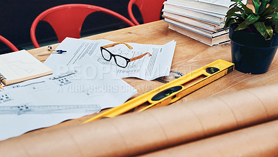 Buy stock photo Still life shot of a pair of spectacles placed on top an architect's blueprints in a modern office