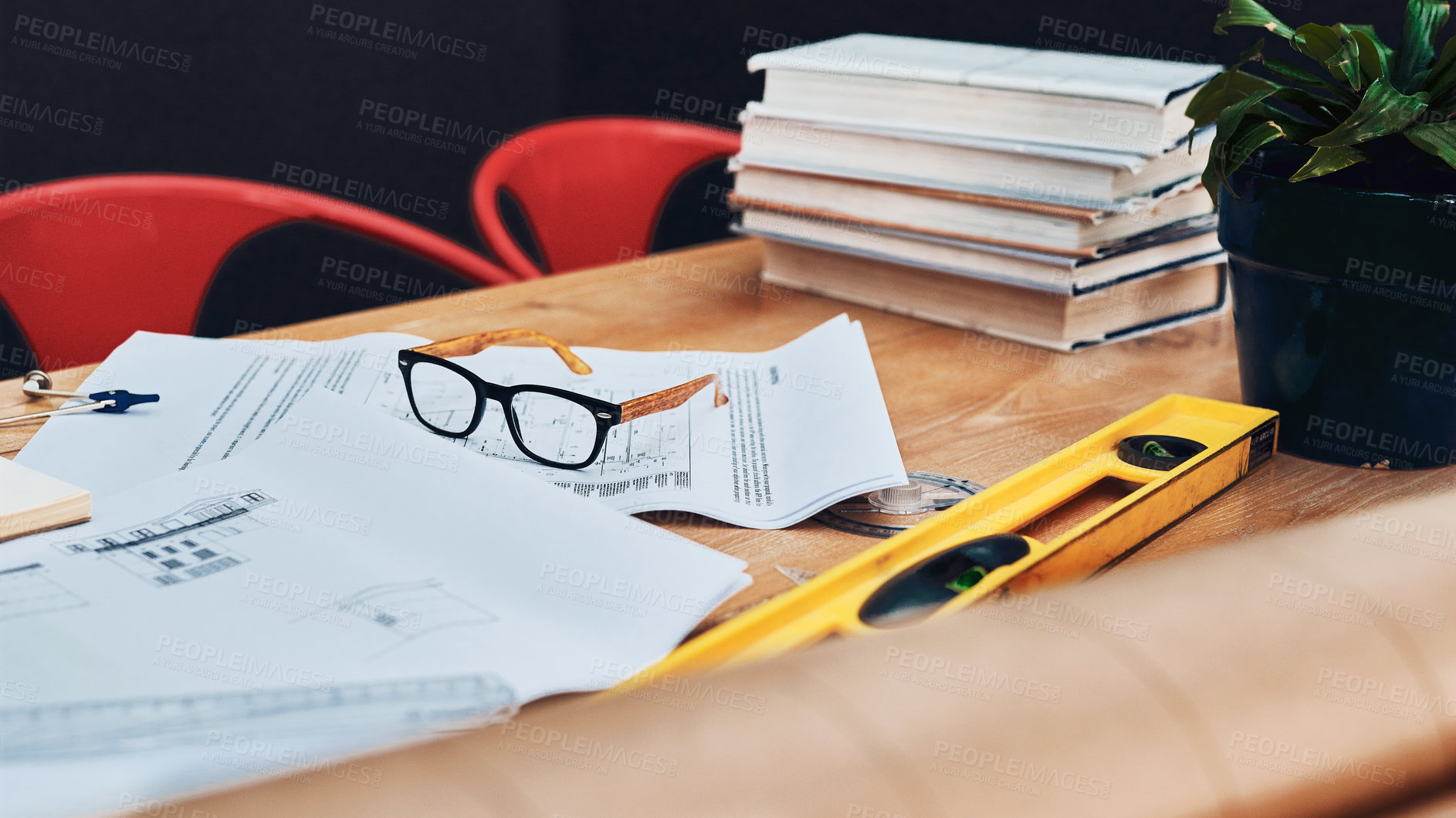 Buy stock photo Still life shot of a pair of spectacles placed on top an architect's blueprints in a modern office