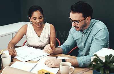 Buy stock photo Cropped shot of two young architects working together in a modern office