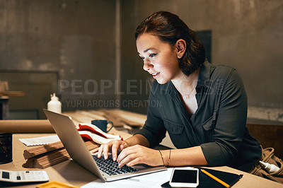 Buy stock photo Cropped shot of an attractive young female carpenter working on her laptop in the workshop