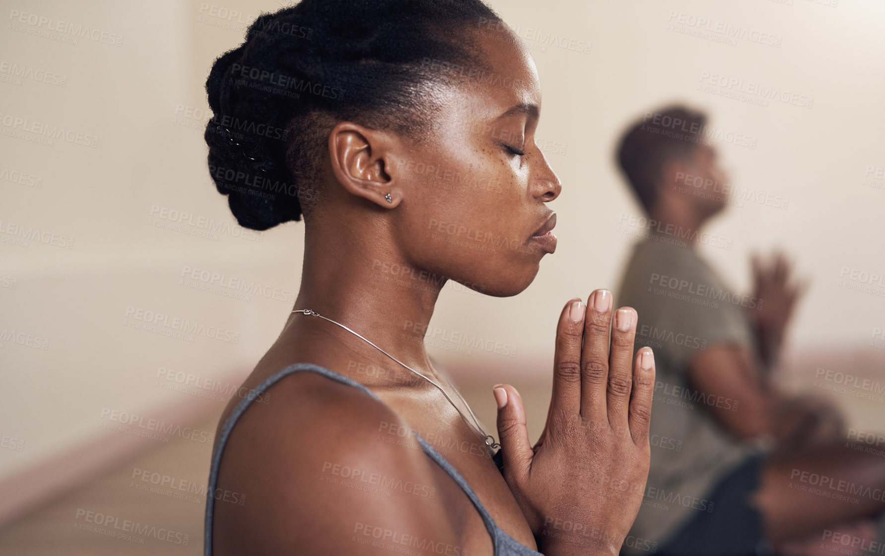 Buy stock photo Shot of an attractive young woman meditating in a yoga class