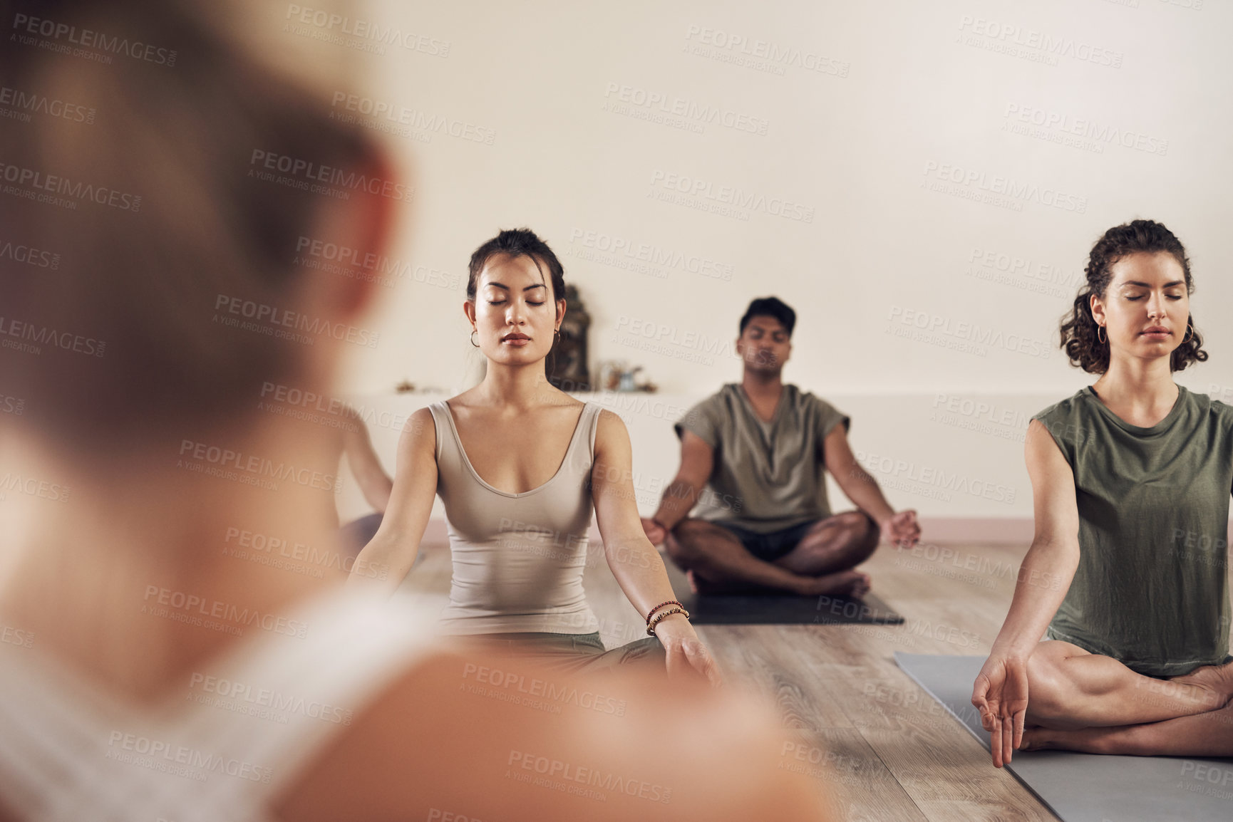 Buy stock photo Yoga, meditation and group in a wellness and health class to relax with zen and peace. Female people, spiritual and holistic exercise with calm lotus pose with workout, fitness and body in a gym