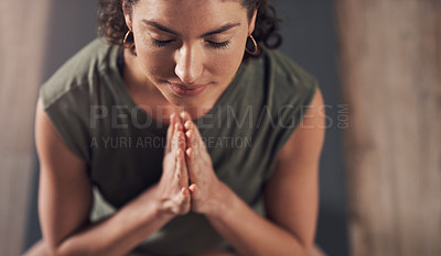 Buy stock photo Shot of an attractive young woman meditating and practicing yoga indoors