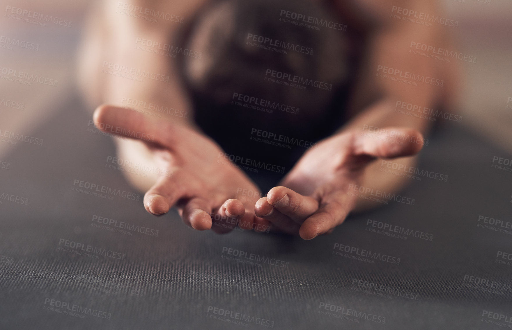 Buy stock photo Shot of an unrecognizable man stretching and practicing yoga indoors