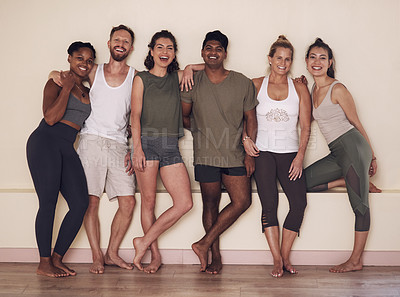 Buy stock photo Full length shot of a group of active young people posing together against a wall in yoga class