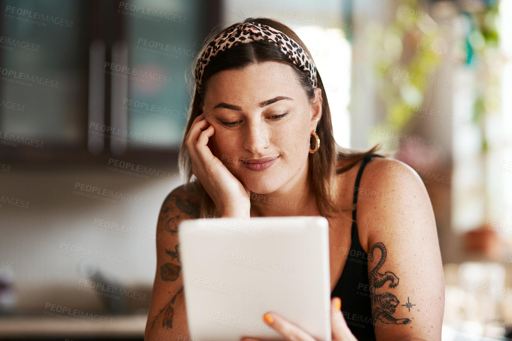 Buy stock photo Woman, reading and tablet in kitchen for ebook, relax and streaming media on internet. Girl, smile and tech in home for food blog website, latest news and social network on weekend with connectivity