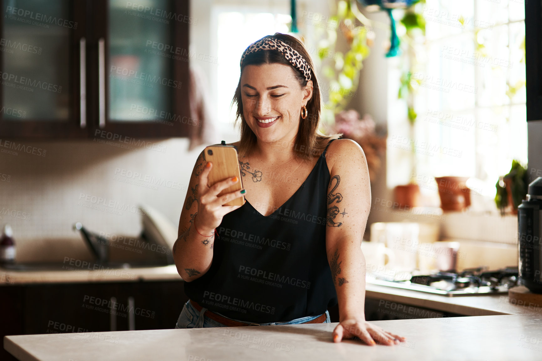 Buy stock photo Happy, woman and phone in kitchen with smile on social media for online recipe for lunch on app. Home, technology and internet search for meal inspiration with video, message or website at counter