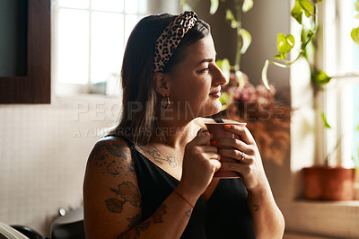 Buy stock photo Shot of a young woman having a relaxing coffee break at home
