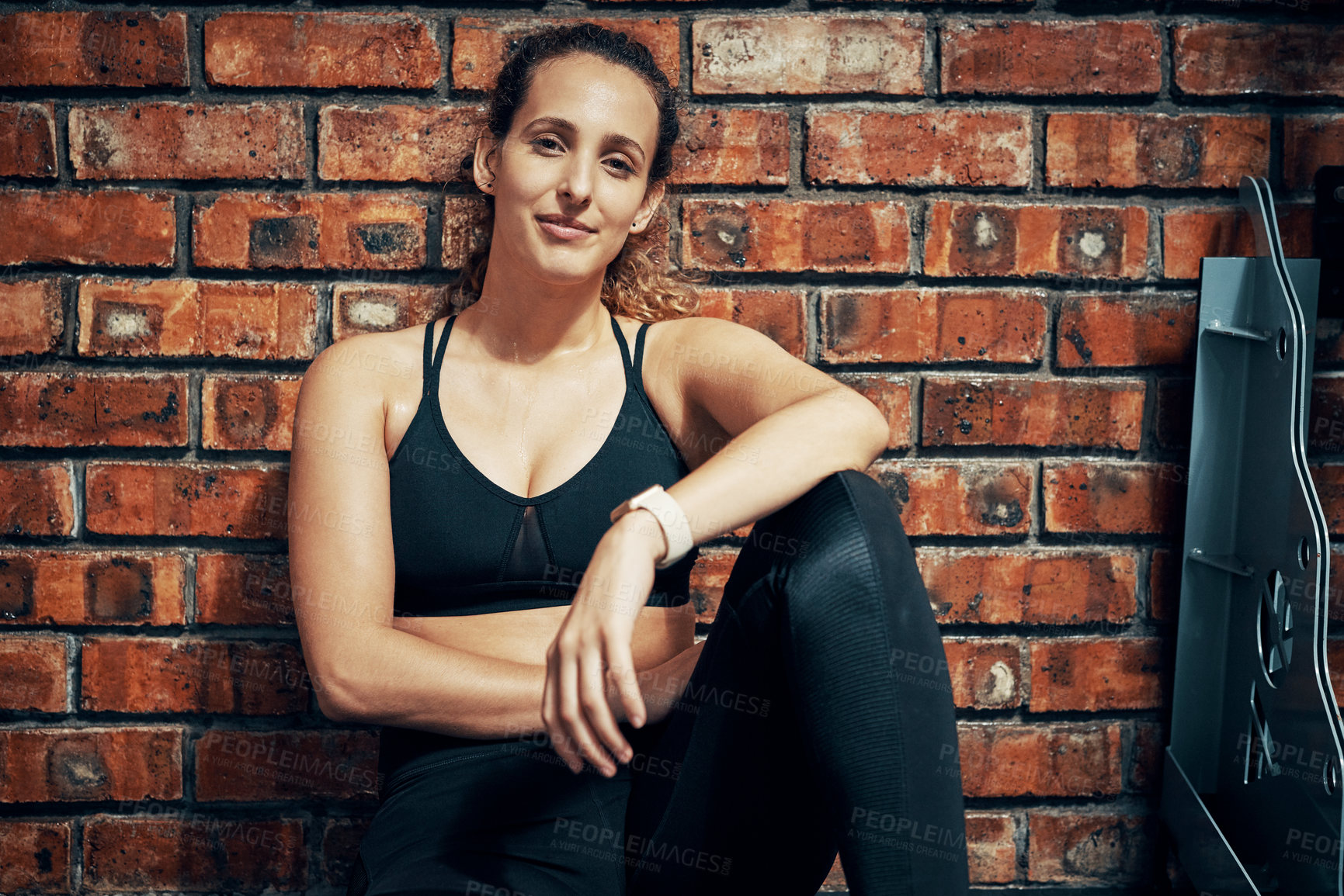 Buy stock photo Cropped shot of a sporty young woman taking a break after her workout