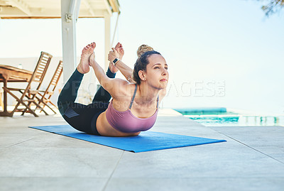 Buy stock photo Shot of a young female athlete practising yoga at home