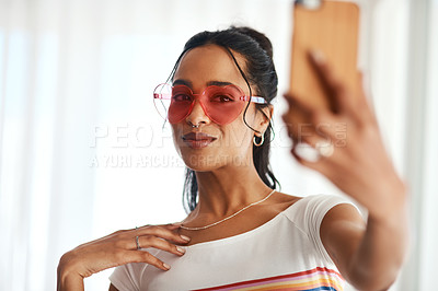 Buy stock photo Cropped shot of an attractive young blogger standing and wearing heart shaped glasses for a selfie with her cellphone