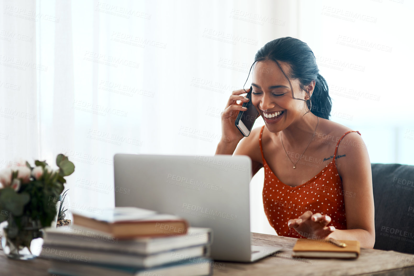 Buy stock photo Happy woman, laptop and laughing with phone call for discussion, conversation or friendly chat at home. Young, female person or author talking on mobile smartphone for humor or comedy in remote work