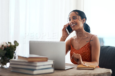 Buy stock photo Cropped shot of an attractive young businesswoman sitting in her office and using her laptop while on a phone call