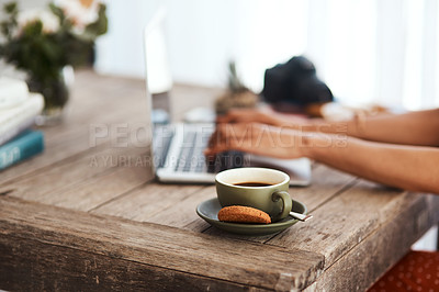 Buy stock photo Cropped shot of an unrecognizable businesswoman sitting alone in her home office and using her laptop