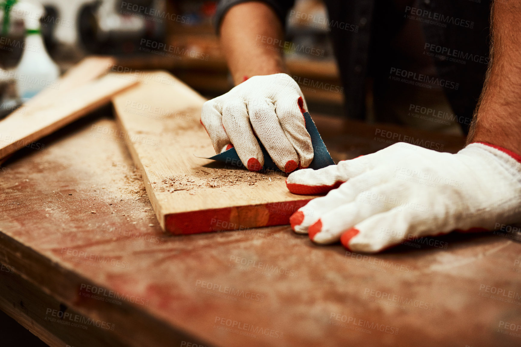 Buy stock photo Carpenter, hands and wood sandpaper for workshop, maintenance and contractor project. Person, tools and builder gloves for protection with home construction, repair and sanding plank at carpentry