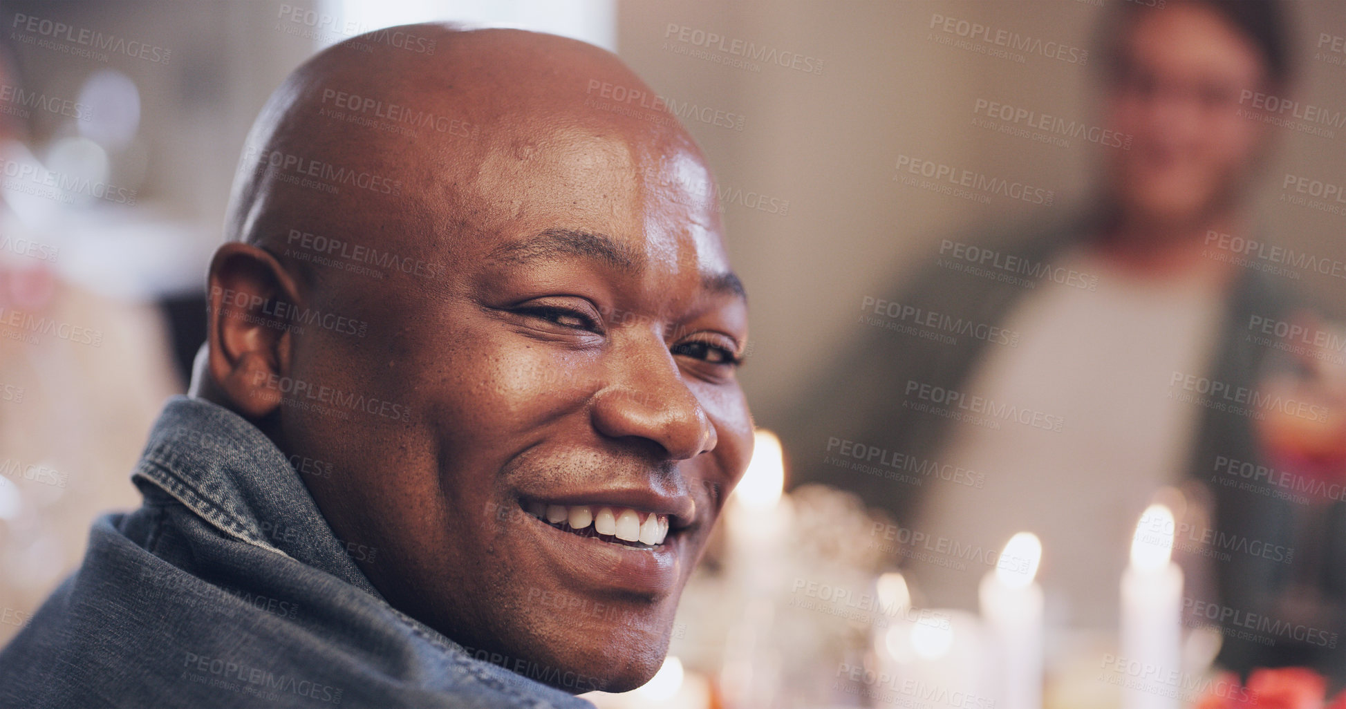 Buy stock photo Dinner party, candles and portrait of African man with friends in house for birthday, celebration and food. Christmas meal, table and male person with people in home for social, holiday and eating