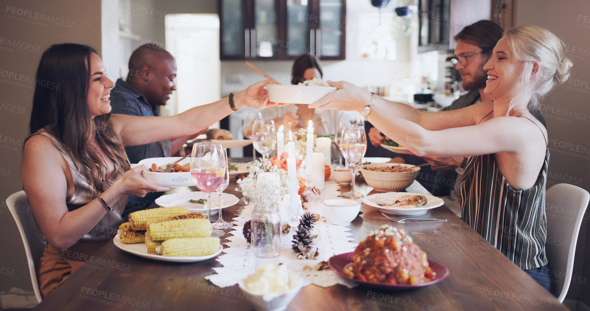 Buy stock photo Christmas, celebration and friends eating lunch, hosting and happy with food at dining room table as a group. Party, social and men and woman with a festive dinner during Thanksgiving holiday